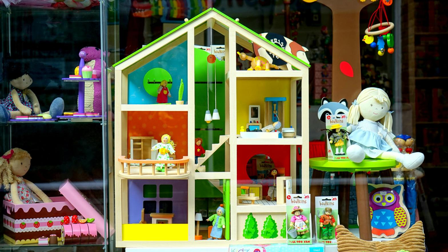 A colorful arrangement of toys around a playhouse