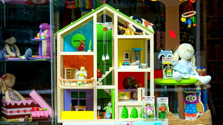 A colorful arrangement of toys around a playhouse
